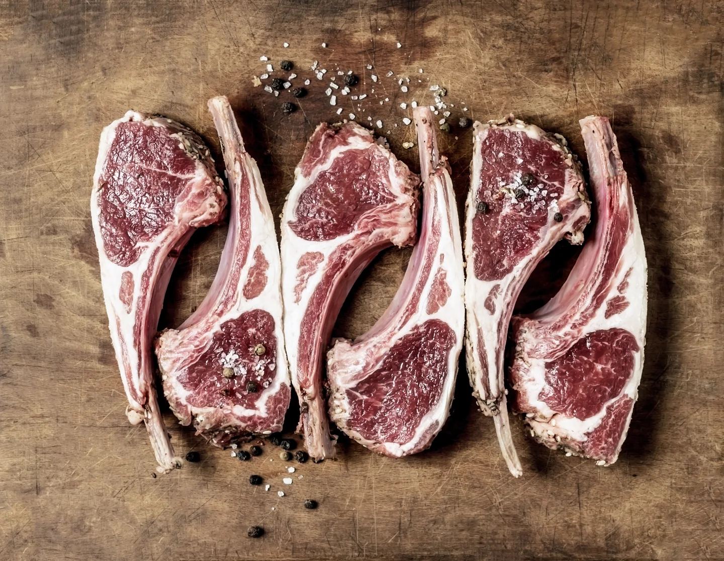 Prepared lamb cuts on a wooden board